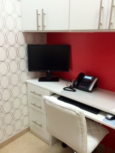 Home office, symmetry closets, custom desk, red paint, office computer, office phone, white hciar, white office, white desk