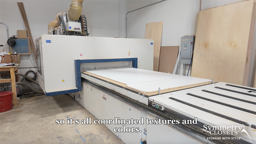 Industrial CNC router and panel processing machinery in a custom cabinetry workshop.
